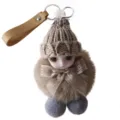 Detailed close-up of a cute plush doll keychain featuring a knitted hat and satin bow - Brown