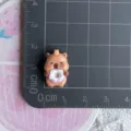 Mini cute capybara resin charm detail showing size on grid, perfect for DIY craft decoration. - Doughnut Eating Capybara