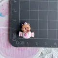 Close-up detail of the cute miniature capybara resin charm with strawberry and cream design. - Pink Strawberry Candy Capybara