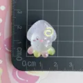 Closeup detail view of a cute resin squid accessory with glitter, perfect for DIY phone cases. - Glittering Purple Expression Cuttlefish