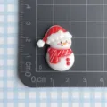 Resin Christmas snowman cabochon charm detail view with red hat and scarf decoration. - Snowman