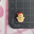 Christmas gingerbread man resin cabochon detail shot clearly showing size on grid mat - Small-Christmas Hat Gingerbread Man (F061)