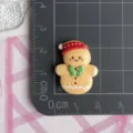 Resin Christmas gingerbread man cabochon detail view showing exact size on grid ruler. - Large-Christmas Hat Gingerbread Man (F061)