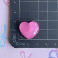 Detailed close-up of a sparkly pink heart resin cabochon accessory for DIY crafts and phone cases. - Rose Red Glitter Heart