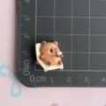 Cute cartoon resin capybara detail shot showing compact size on measurement grid mat. - Beach Lounge Chair Capybara / Mini