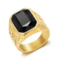 Close-up of a gold-colored men's ring with a large black gemstone and Masonic carvings - Size 7 / Black