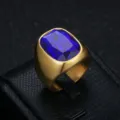 Close-up of a gold-plated stainless steel men's ring featuring a large blue gemstone. - Size 7 / Blue