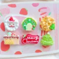 Close-up detail of cute Christmas resin flatback charms, featuring Santa, gingerbread man, and tree. - Random Mixed Fruits