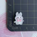 Mini resin rabbit charm detail view showing size on grid ruler for DIY craft accessories and phone case. - White Luminous Rabbit