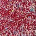 Close up detail view of mixed DIY craft beads, pearls, and colorful heart sequins. - Dark Red