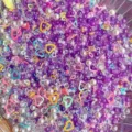 Mixed DIY craft beads pearls rhinestones and colorful heart sequins for handmade accessories. - Deep purple