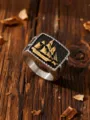 Close-up of vintage stainless steel ring featuring a golden sailing ship relief. - Size 7 / Two-Tone Gold