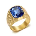 Close-up detail of a gold hammered stainless steel ring with a large blue zircon - Size 7 / Blue