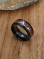 Macro view of black stainless steel ring with wood grain inlay and deer silhouette - Size 7 / Steel