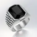 Close-up of a men's stainless steel ring with a large faceted black square gemstone - Size 7 / Black