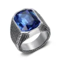 Macro detail of a retro stainless steel ring with a large square blue zircon stone - Size 7 / Blue