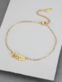 Close-up detail of a gold titanium steel anklet featuring the word Virgo in Old English font - Virgo