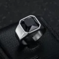 Macro view of a men's stainless steel ring featuring a square black gemstone inlay - Size 7 / Steel Color Black Stone