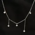 Close-up view of the sparkling silver zircon multi-drop necklace highlighting delicate chain links. - 925 Silver / White Gold