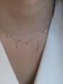Delicate gold-tone pendant necklace with sparkling cubic zirconia charms for elegant details. - 925 Silver / Gold