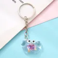 Delizioso portachiavi granchio in acrilico trasparente con fiori secchi, ciondolo per borsa. - Viola