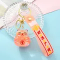 Cute liquid quicksand lucky cat keychain with pink silicone strap and shiny glitter details. - Orange