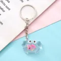 Portachiavi granchio in acrilico trasparente con anello in metallo e glitter interni. - Rosa