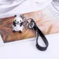 Cute geometric panda keychain with black silicone strap and metal ring, perfect bag charm. - Panda