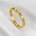 Close-up of gold stainless steel ring featuring a recurring dollar sign pattern design. - Size 6 / Gold