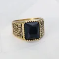 Close-up of a gold titanium steel men's ring with a large square black gemstone - Size 7 / Black