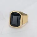 Close-up of men's square black gemstone ring with gold-plated titanium steel band. - Size 7 / Black