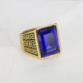 Detailed macro view of vintage hip hop ring with blue gemstone and Greek key engraving - Size 7 / Blue