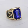 Detailed macro shot of gold men's Masonic ring featuring a large faceted blue crystal gemstone - US 7 (54.3mm) / Gold Blue Rhinestone