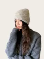 Close-up detail of the cozy wool blend speckled knit beanie hat worn by model for warmth. - One Size / Off White
