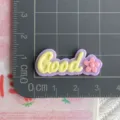 Close-up detail of DIY resin Good letter charm with cute pink flower, perfect for crafts. - GOOD Letter / Glossy / Purple