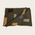 Close-up view of a stylish color-block knitted winter scarf featuring geometric patterns. - 140cm / Army Green