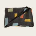 Close-up detail of women's cozy knit scarf with colorful geometric block patterns. - 140cm / Dark Gray