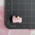 Close-up detail view of the mini pink rabbit resin charm with English text on grid mat. - Pink Rabbit (Rabbit) / 1 Piece / Pink