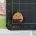 Detailed view of cute resin acorn food charm cabochon for DIY phone case craft decor. - Chocolate Nut