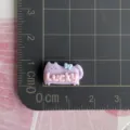 Detailed close-up of a cute purple resin cat charm with pink Lucky letter design for DIY crafts. - Purple Cat (Lucky) / 1 Piece / Purple