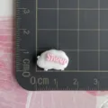 Mini resin sheep charm with pink letters detail shot for DIY hair clips phone cases. - White