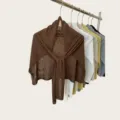 Detailed view of women's lightweight knitted shawl scarf draped on a rack in dark brown color. - 180cm / Coffee