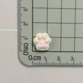 Resin cat paw charm detail shot showing compact size on measurement grid for DIY crafts. - Cat Paw (C093实色小猫爪) / Pink