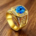 Detail of luxury men's vintage gold-plated ring with large blue zircon and carvings - Size 8 / Blue