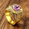 Close-up of men's retro engraved gold ring featuring a large round pink zircon - Size 8 / Pink