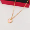 Close-up detail of stainless steel pink heart pendant necklace with enamel beads on chain. - Pink