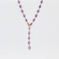 Close-up detail of a stainless steel purple evil eye Y necklace, dainty chic collarbone chain. - Steel / Purple