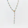 Close-up detail view of stainless steel gold evil eye Y necklace pendant charm link accessory. - Steel / White