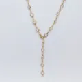 Detailed view of gold stainless steel Y-shaped necklace sparkling clear glass stones bohemian style. - White