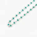 Close-up detail view of stylish stainless steel green heart chain link necklace jewelry. - Emerald